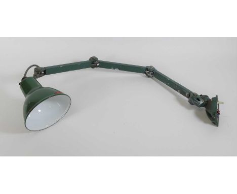 A 20th century industrial green painted metal adjustable desk lamp, having a green enamel shade 