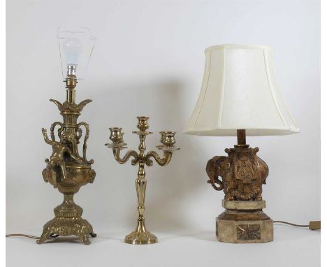A gilt resin table lamp in the form of an elephant, height 56cm including shade, together with a brass table lamp, and a bras