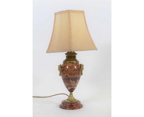 A rouge marble and gilt metal mounted table lamp, flanked by masks, height 50cm including shade, together with three further 