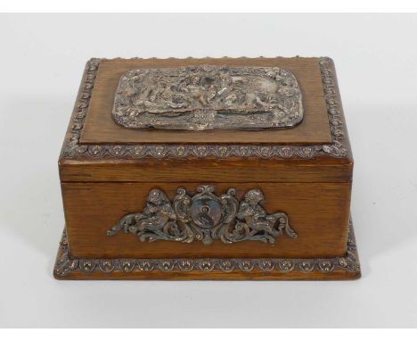 An early 20th century oak and silver plated mounted twin compartment tea caddy, the lid relief decorated with a neo classical