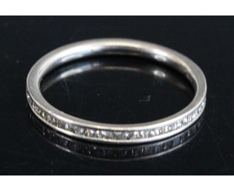 A modern platinum diamond half eternity ring, channel with 26 small princess cuts, 2.2g, size N, with Beaverbrooks box and ou