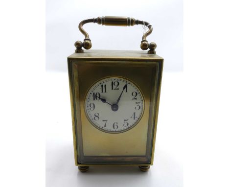 An early 20th century French lacquered brass carriage clock, the enamel dial showing Arabic numerals, height 10cm