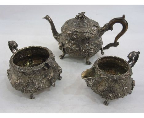 Georgian silver teaset, milk jug and sugar bowl with embossed floral decoration, the C-scroll cartouche bearing a double cres