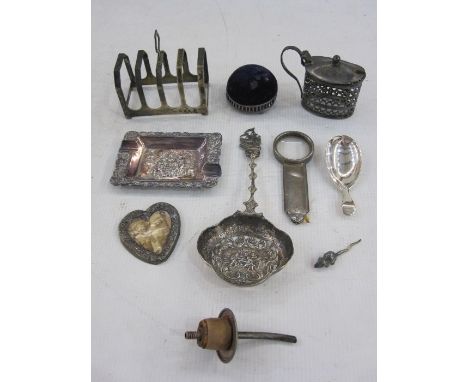 Silver&nbsp;four division toast rack,&nbsp;Birmingham 1933, a silver caddy spoon, a silver mounted circular pincushion and va