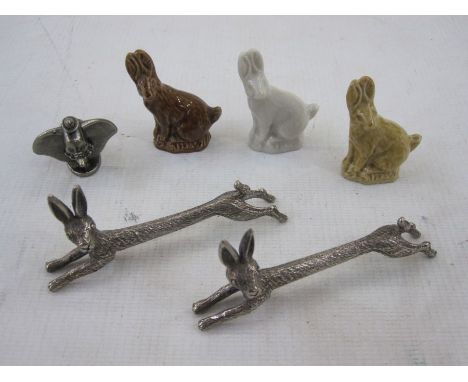 A pair of silver plated hare knife rests, three Wade china hares and a metal figure of Dumbo marked Disney (6)