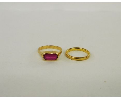 A gold and ruby-coloured stone lozenge set ring, marked indistinctly to outside of band, 3g in total and a gold coloured wedd