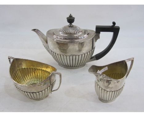 Silver three-piece teaset by Goldsmiths and Silversmiths Co. Ltd., London 1912 of semi-fluted oval design comprising teapot, 