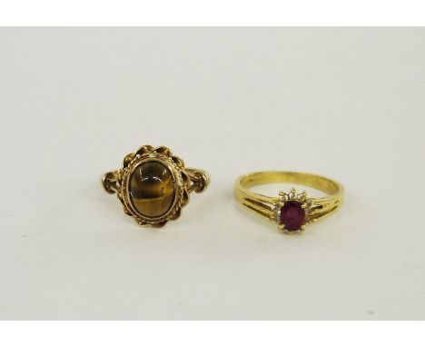 9ct gold and tigers eye cabochon set ring, 3.5g approx. and a 14K gold ruby cluster set ring, 2.5g approx. (2)&nbsp;