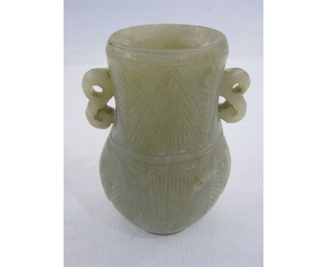 Chinese carved jade baluster vase of flattened form, having pair S-scroll handles and the body carved with stylised leaves, 1