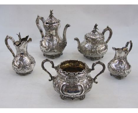 Late Victorian silver tea and coffee service of five pieces, crested and decorated with embossed C-scroll and flowerheads, on