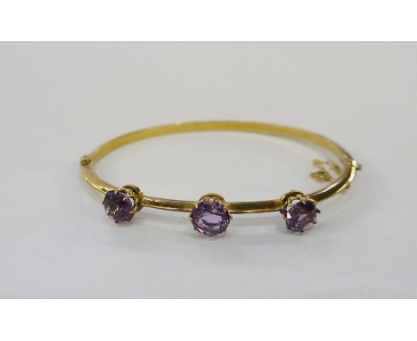 9ct gold and amethyst bangle set three claw set amethyst stonesCondition ReportApprox length 15.5cm