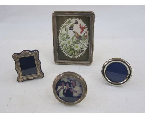 Rectangular silver photograph frame, Birmingham 1922, a smaller engine-turned silver circular photograph frame and two small 