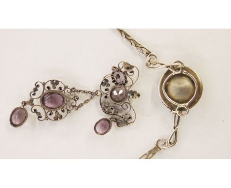 White metal, amethyst and seedpearl pendant, the amethyst set within a scrolling wirework frame, 7.5cm long (with losses) and