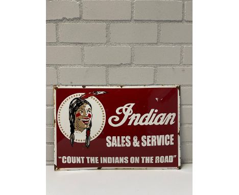 Indian Sales &amp; Service enamel sign with dark red background and showing Indian logo on the upper left of the sign. At the