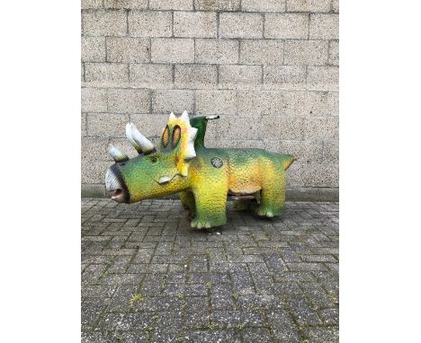 Coin-operated children's fairground dinosaur Triceratops attraction. The dinosaur features a coin Slot, 4 wheels, LED light p