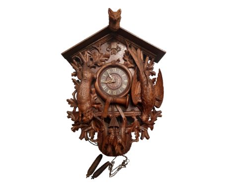 Black Forest Cuckoo clock with weight-driven mechanism and nicely carved details. Broken ear tip on the fox head and minor da