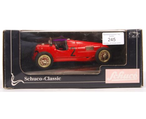 A Schuco Classic made 1:18 scale (approx) tinplate clockwork model No. 01221 ' Studio II Auto Union '. Red, with black seat a