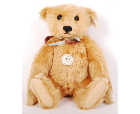 A 20th century Steiff reissue teddy bear ' 1907 Hellbraun '. Brown mohair, with glass eyes. Complete with ear tag, scarf and 