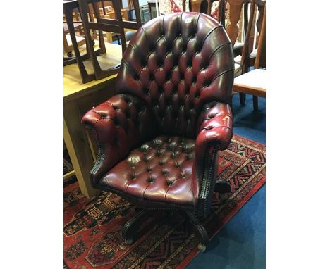 A burgundy Chesterfield button back swivel armchair
