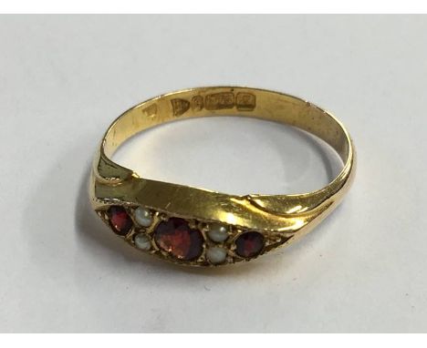 A 9ct pearl and garnet ring