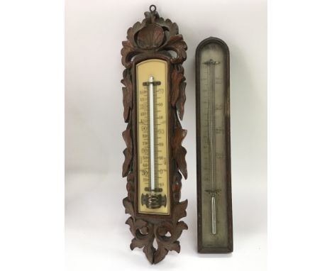 A carved oak barometer and one other, largest approx 38cm.