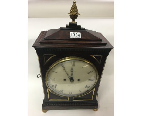 A Georgian mahogany bracket clock, circular dial with Roman numerals. Maker William Hurst
