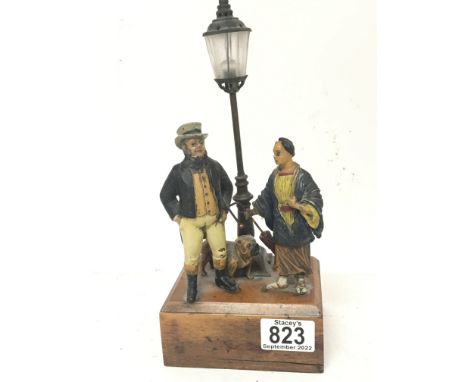 An unusual early 20th century table lamp with painted metal figures East meets West with a pug dog at foot standing by a lamp