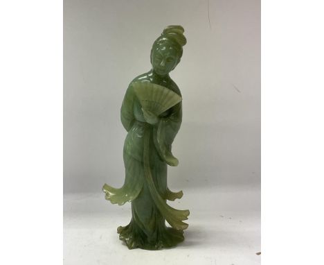 A Chinese green Jade figurine of a court dancer.