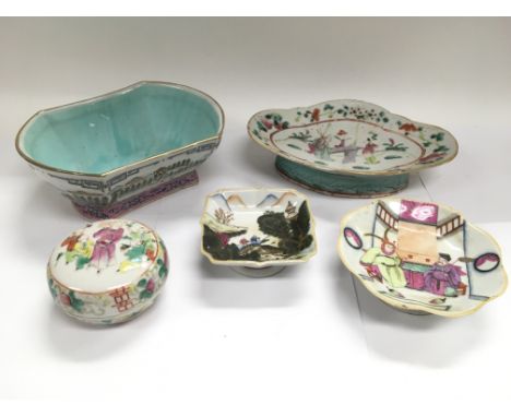 Five Oriental ceramic items comprising a circular box and cover decorated with figures together with four various footed dish