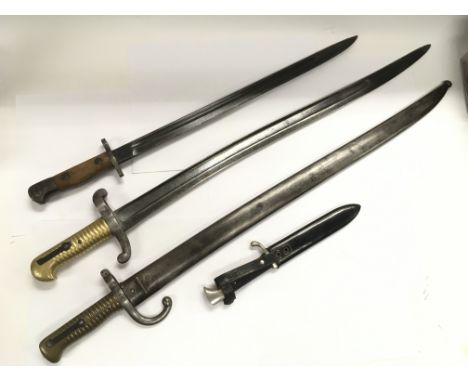 Two 19th Century French sway blade bayonets with brass grips together with a German dagger and one other bayonet (4).
