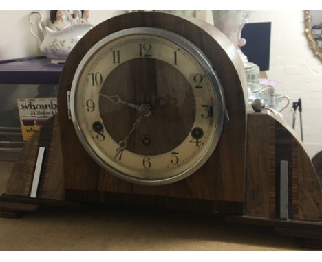 A quality Art Deco walnut and chrome mantel clock with three train movement.