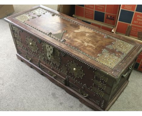 A Mahogany trunk with applied brass embellishments the trunk with a hinged top above three drawers. 