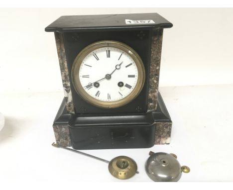 A Victorian black slate and marble mantel clock the French movement striking on a bell.