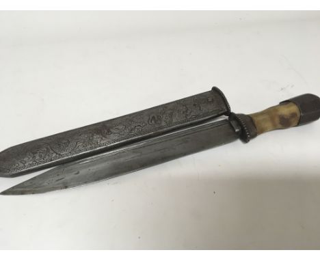 A late 19th century dagger or short sword with a horn handle the scabbard engraved with dragons. length 37cm.