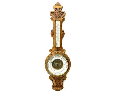 Early 20th century carved oak card aneroid barometer with visible aneroid and mercury thermometer, by �C. J. Gowland, Sunderl