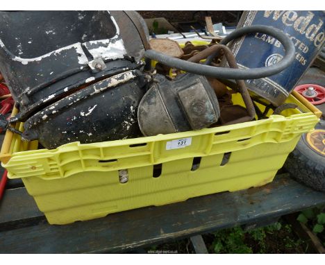 A box of metal items, balance scales, a griddle, shackles, an old possibly railway lamp, a sheep marker, a carbide headlamp w