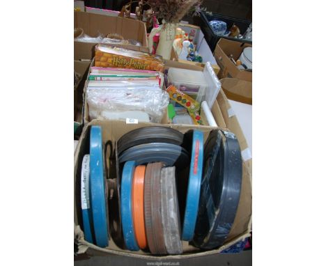 A box of crafting items and a box of film reels.