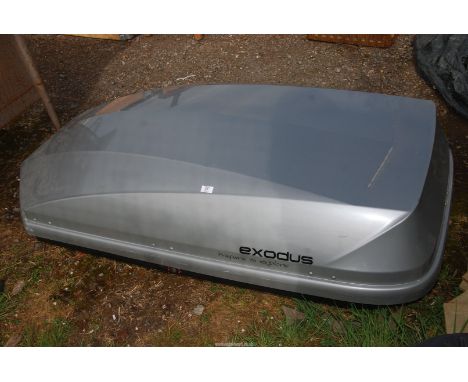 An "Exodus" car roof box, approx 64" x 34" x 17" high, (keys in office).