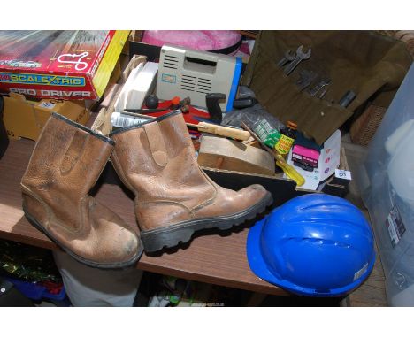 A box of miscellaneous tools, safety boots, hat etc.