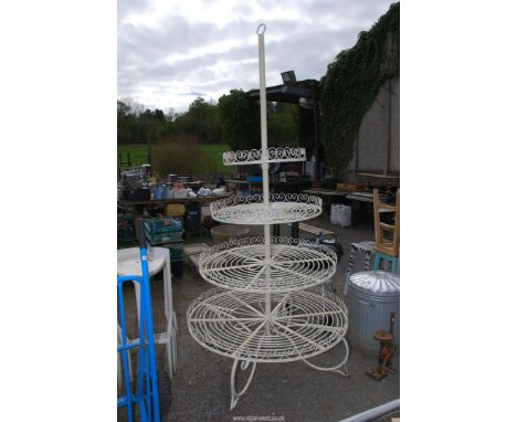 A large wrought iron plant stand finished in cream, approx 8ft tall, widest part being 45" wide.