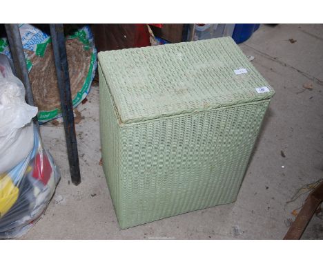 A green painted Lloyd loom style linen basket.