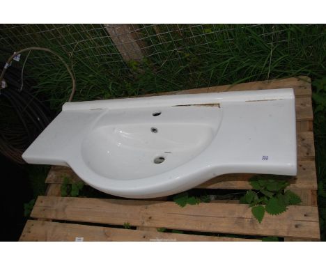 A ceramic bathroom basin, 41 1/4" long x 19 1/2" wide.