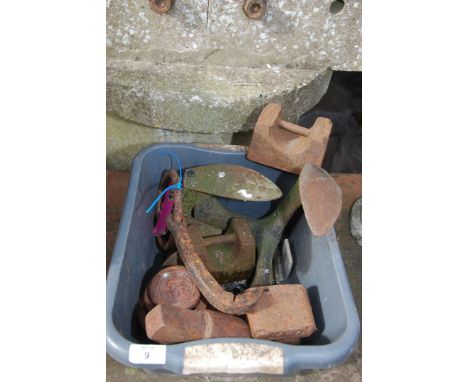 A box of Cast Iron items, shoe lasts, weights, hook, etc.