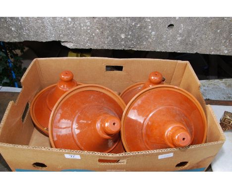 Four glazed cooking tagines.
