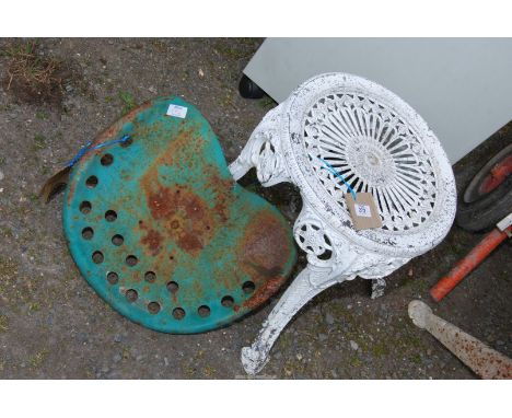 A cast iron tractor seat and a chair base.