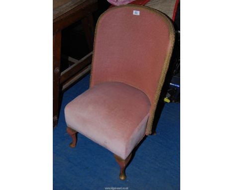 A Lloyd loom style chair.