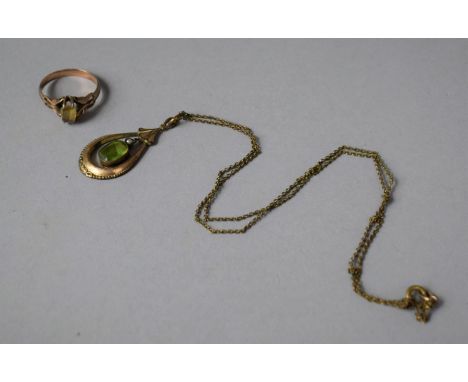 A Yellow Metal Ring, Unmarked and a Similar Pendant Both Having Green Stones 