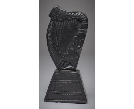 An Irish Bog Oak Souvenir Harp Decorated with Shamrocks and Inscribed 'Erin', 7.25cm high 