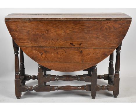 An Early Oak Drop Leaf Gate Leg Table with Oval Plank Top Tuned Supports and Stretchers, 104cm Long 