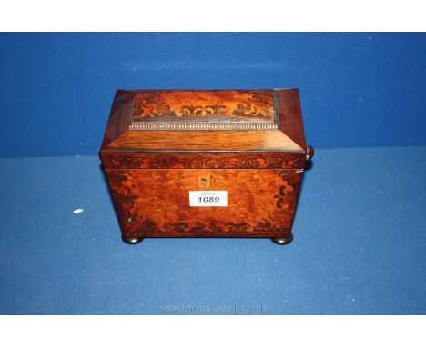 A Victorian inlaid tea caddy.